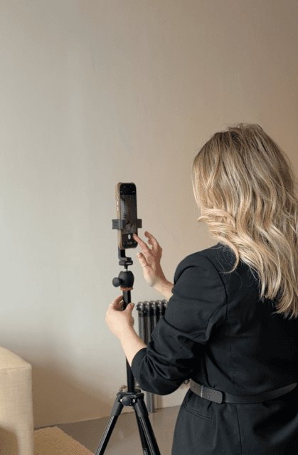 A ROHA team member filming on a phone mounted to a tripod